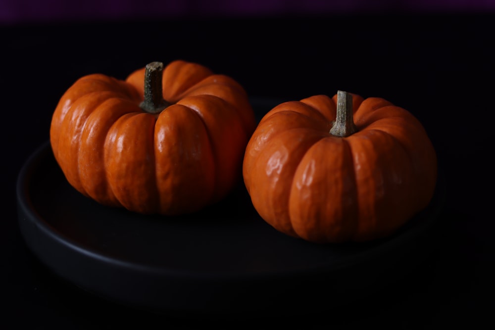 a couple of pumpkins on a plate