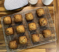 A tray of freshly baked protein muffins cooling on a rack.