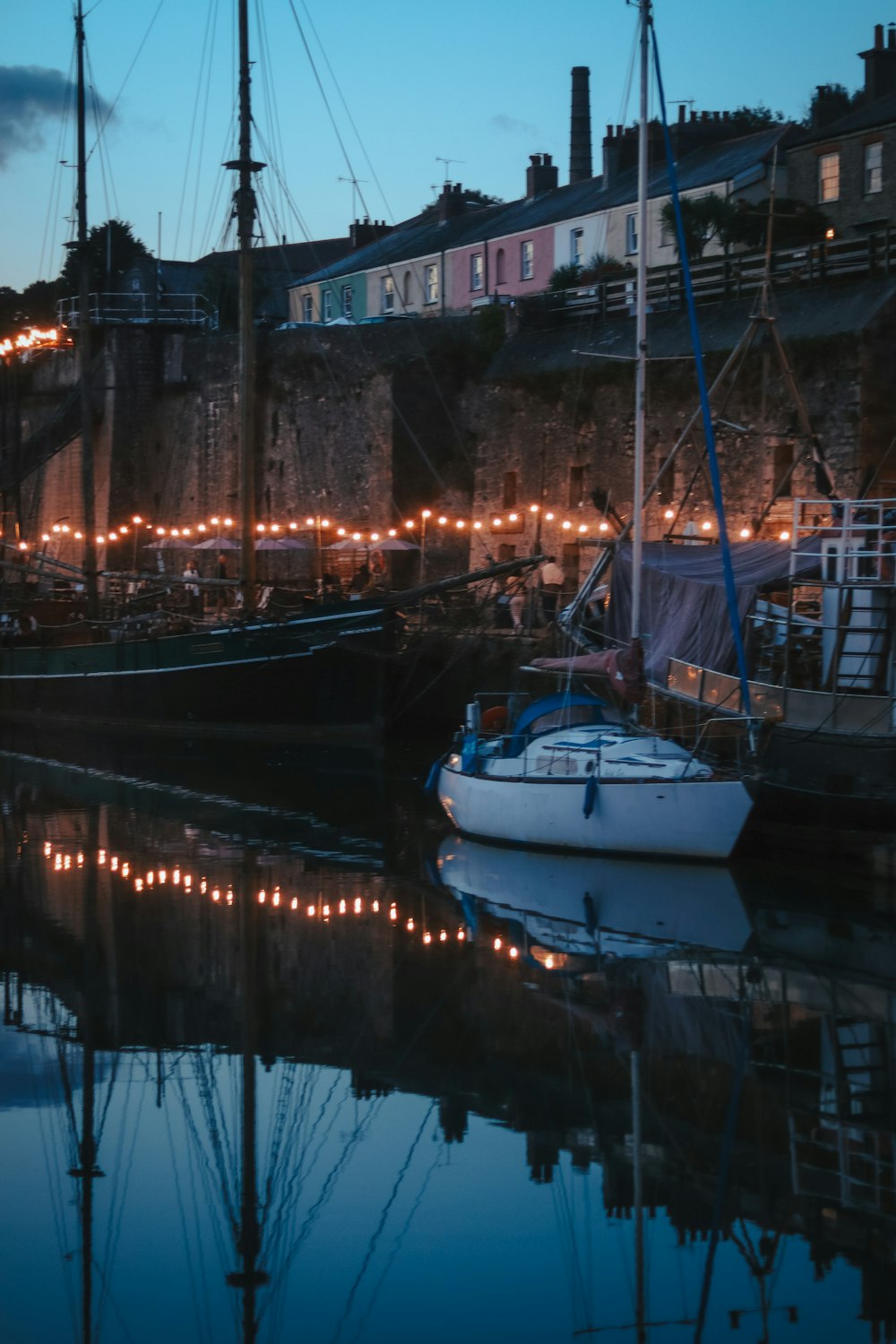 a group of boats sit in a harbor