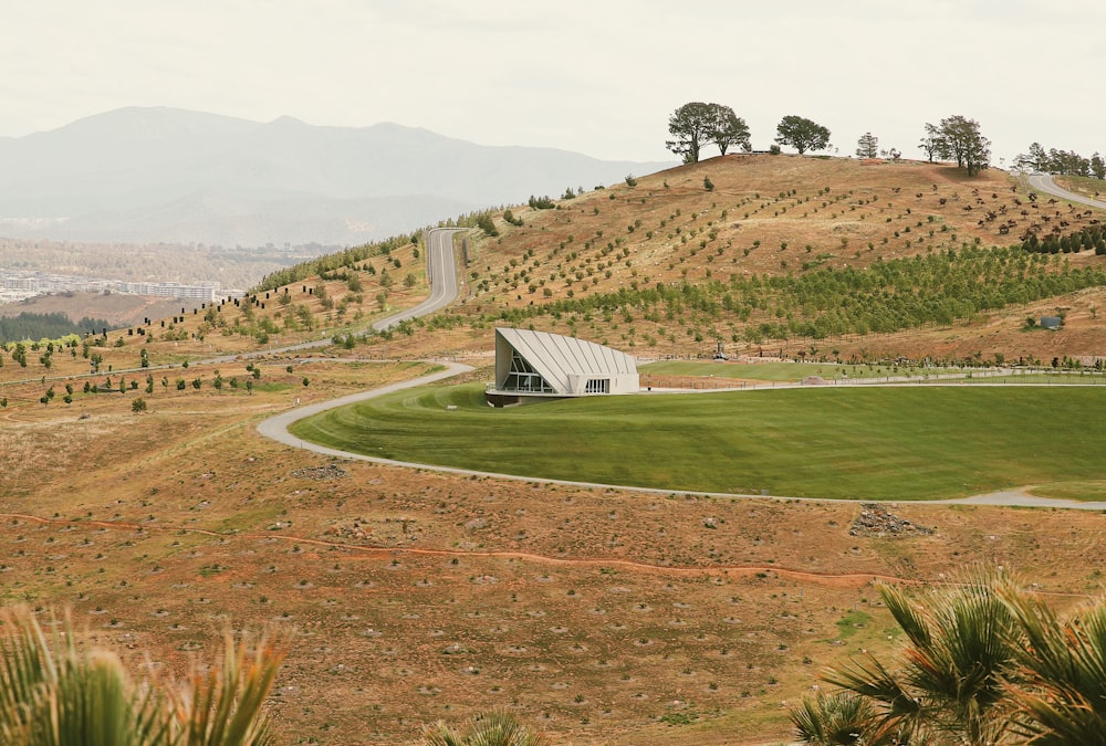 a small white building on a hill