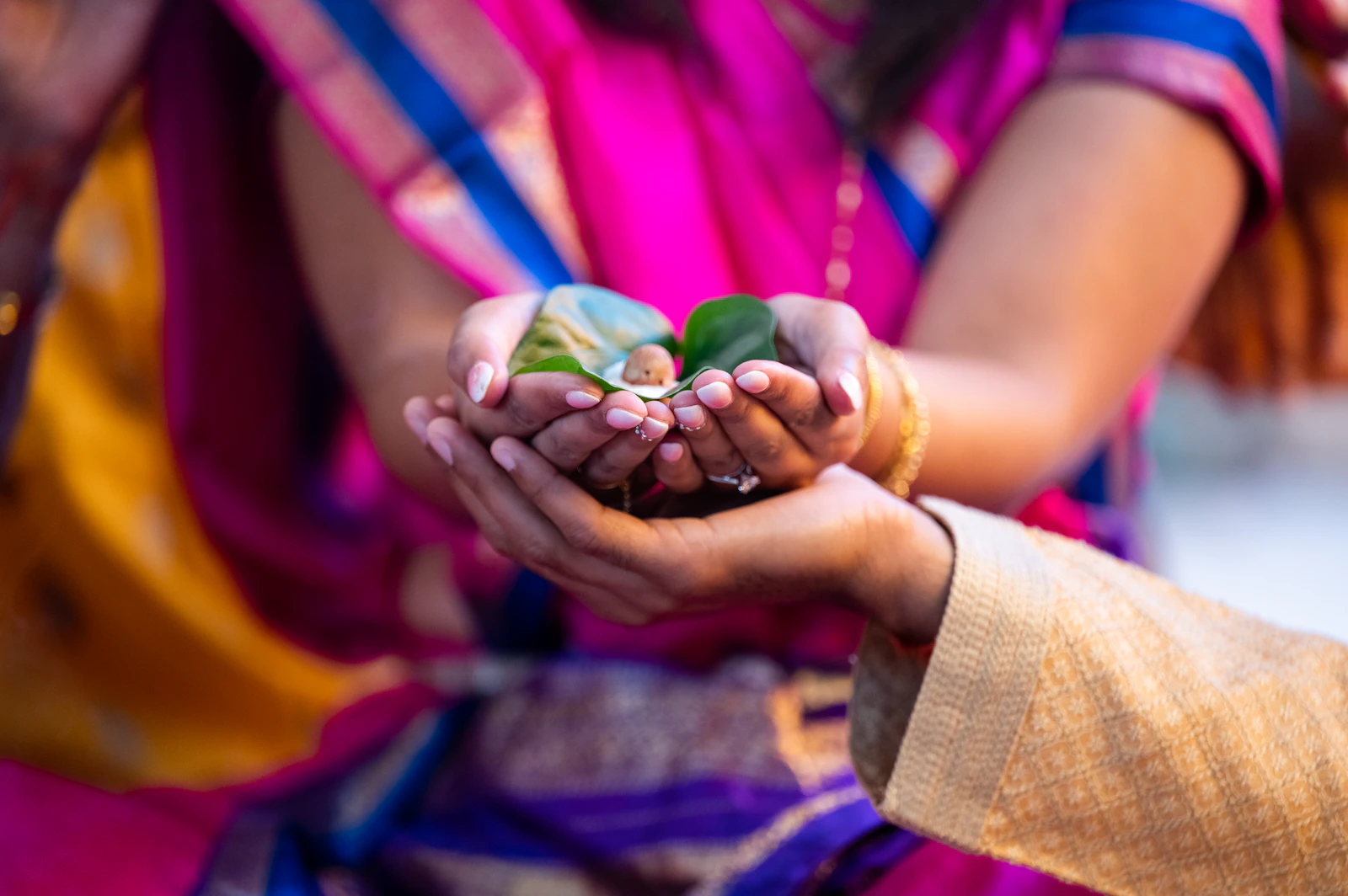 Offerings held in cupped hands during a Hindu ceremony.