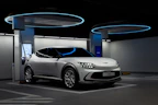 Shiny silver electric car charging at a modern station