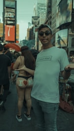 A model wearing a meme-inspired t-shirt in an urban setting.