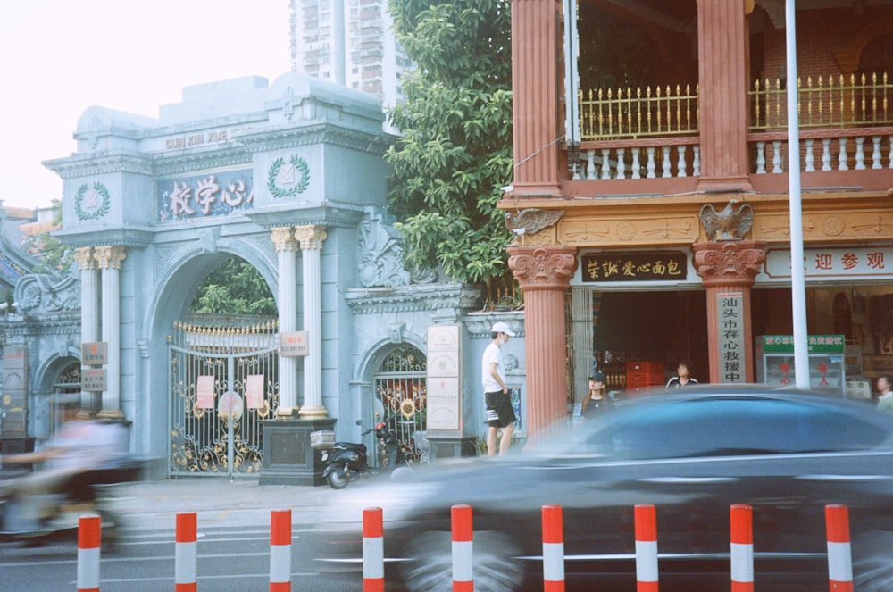 a street with a car and buildings