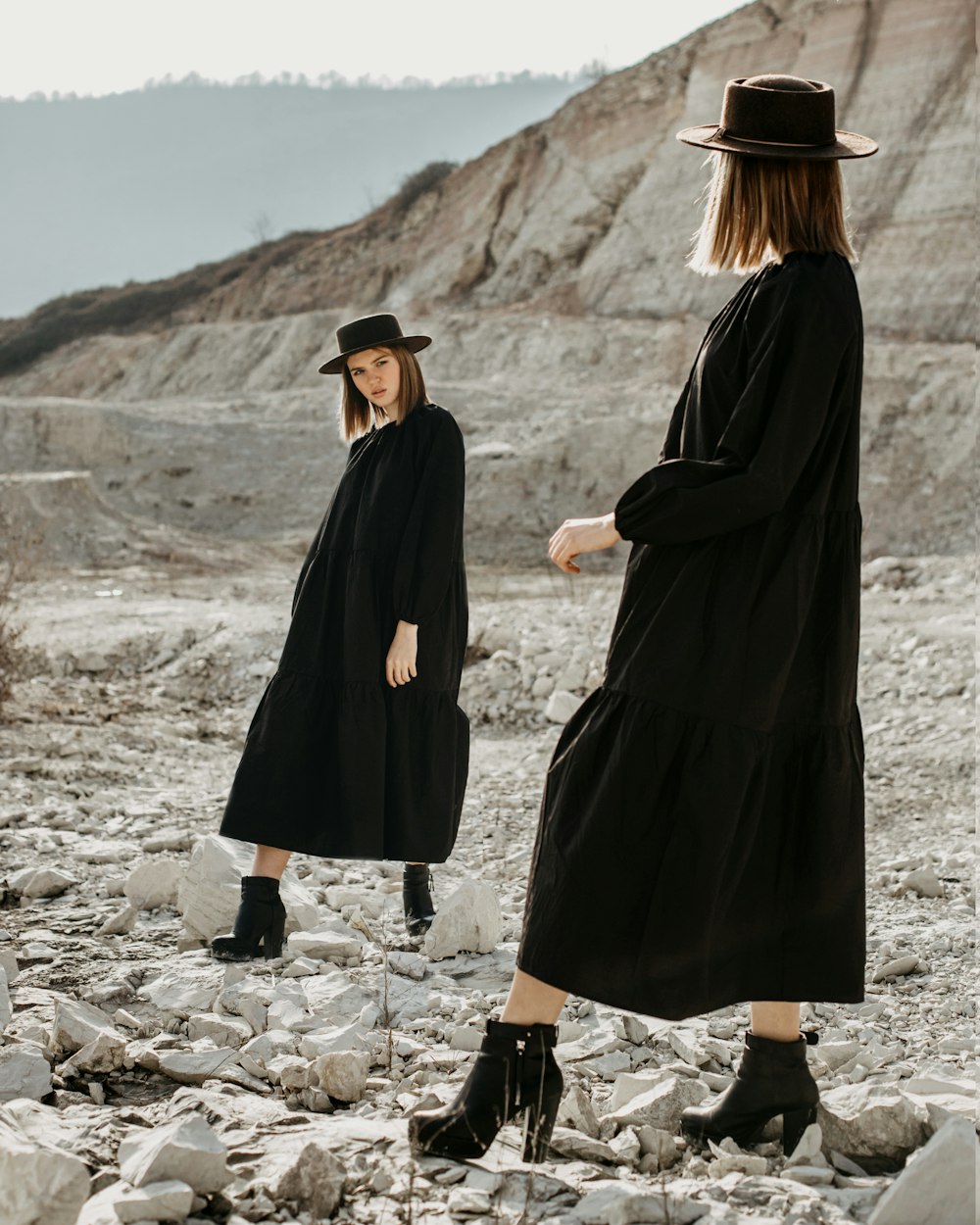 a couple of women in black dresses