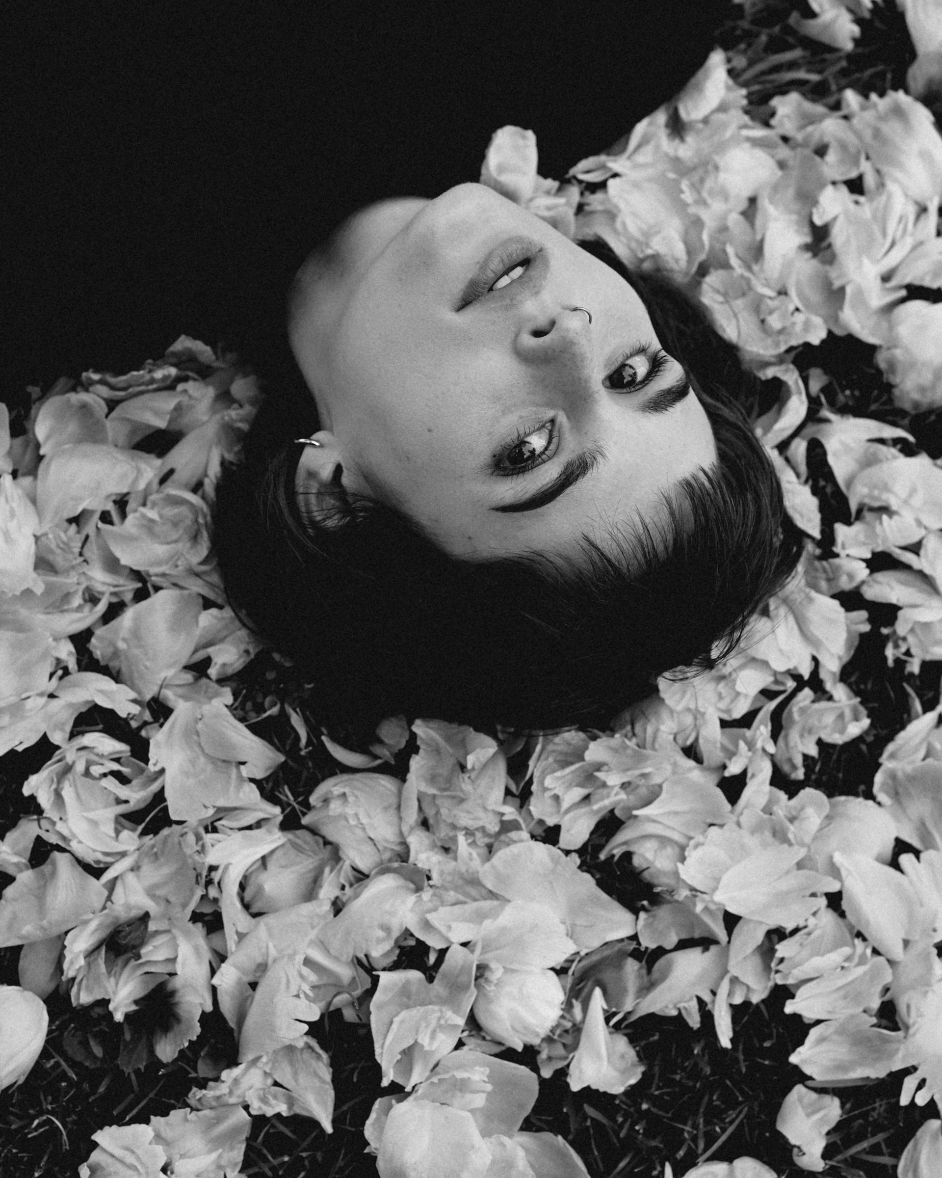 a person lying in a pile of leaves