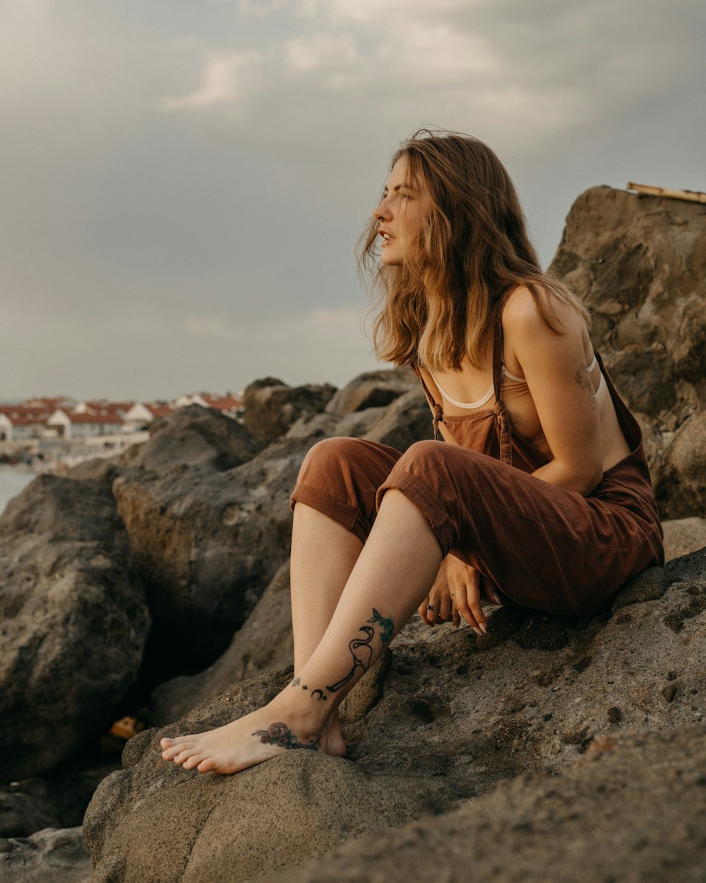 a woman sitting on a rock