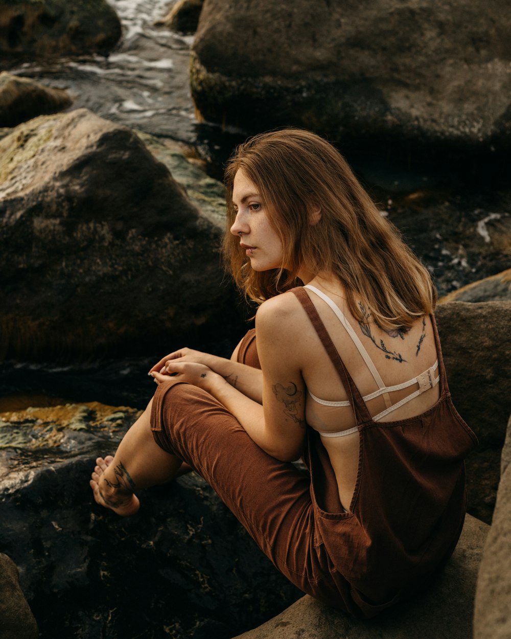 a woman sitting on a rock