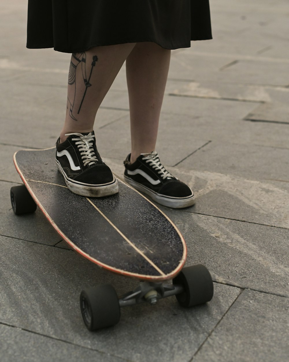 a person stands on a skateboard