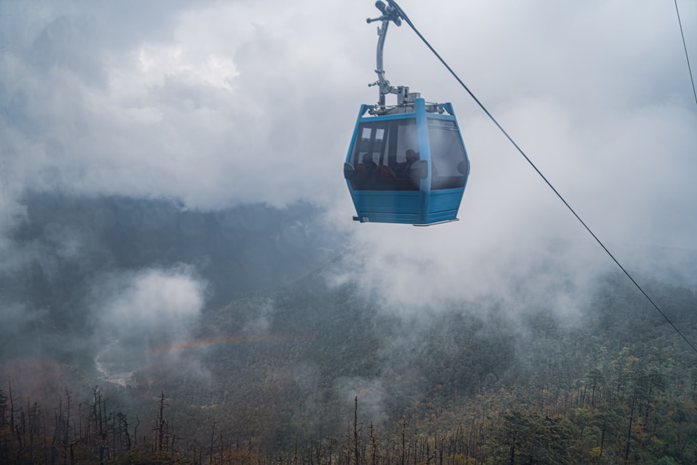 a cable car above a forest