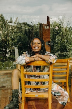 A person happily receiving a chair from a volunteer.