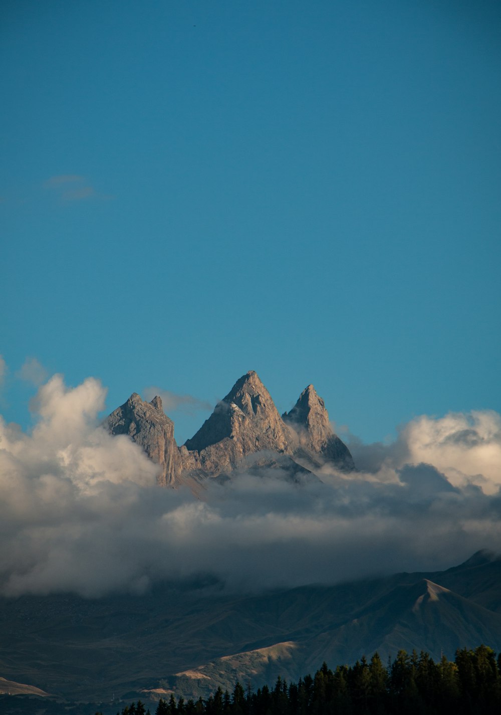 a mountain range with clouds