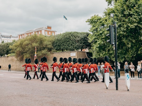 a group of people in red uniforms marching in a parade