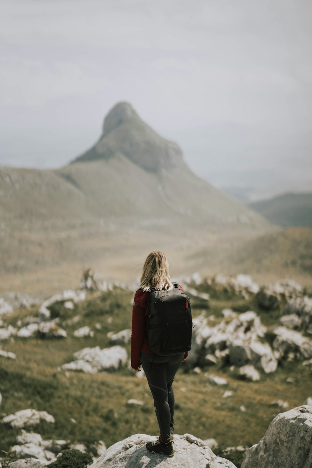 a person walking on a rocky hill