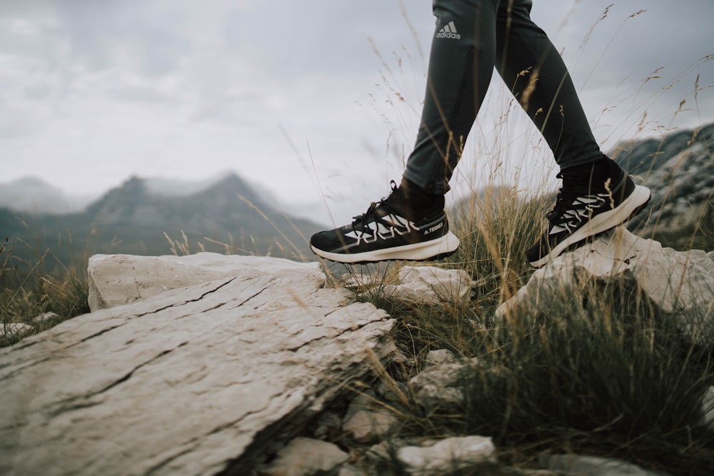 a person's legs on a rock