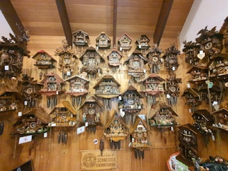 A collection of wooden clocks displayed on a rustic shelf, each with unique glowing epoxy patterns.