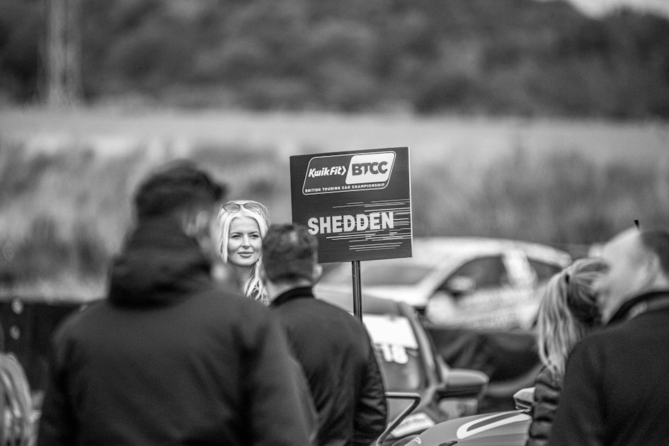 a person stands in front of a sign
