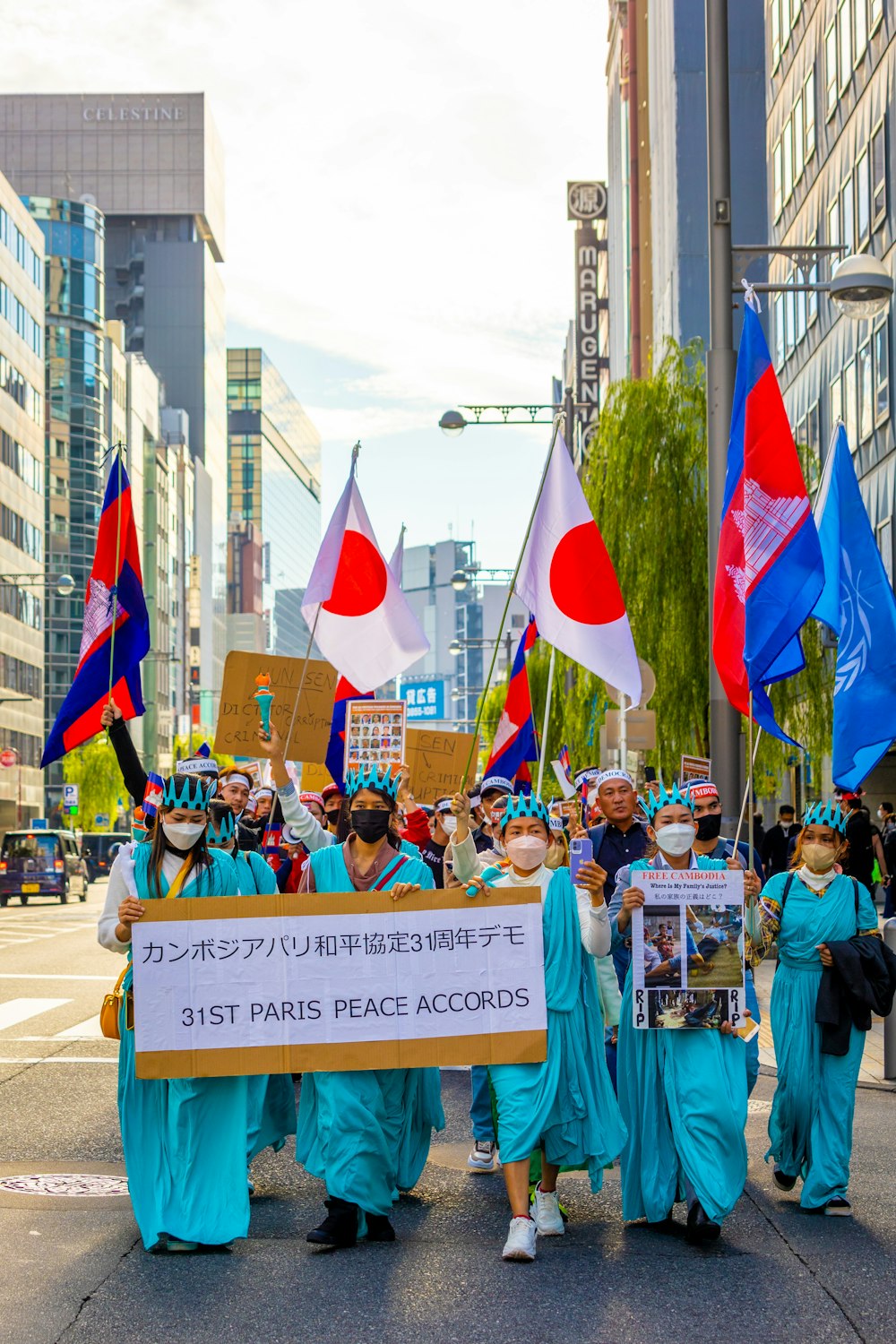 a group of people holding signs and flags on a street