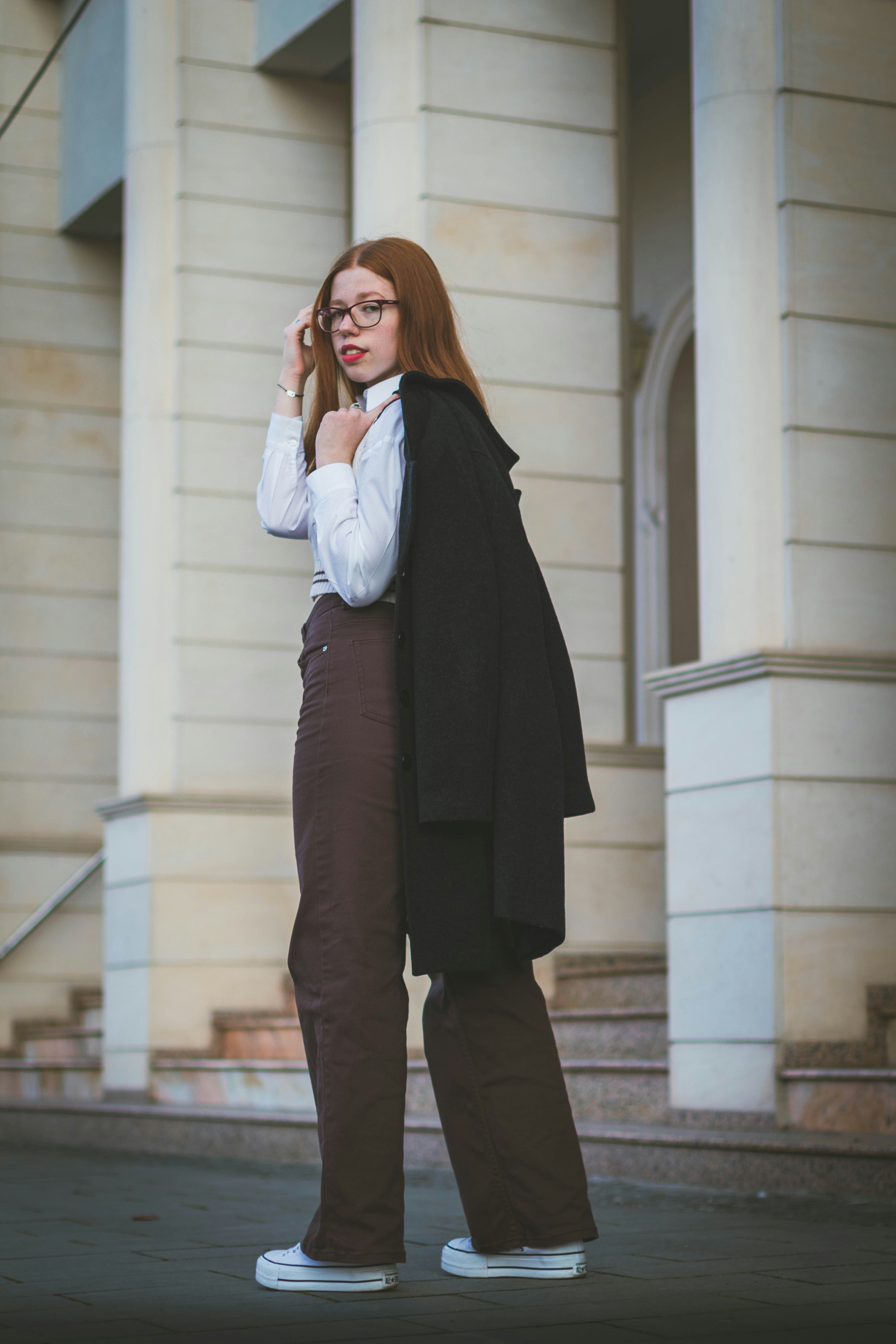 a woman in a suit talking on a cell phone