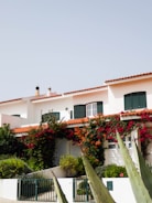 a house with a fence and bushes