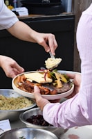 a person holding a plate of food