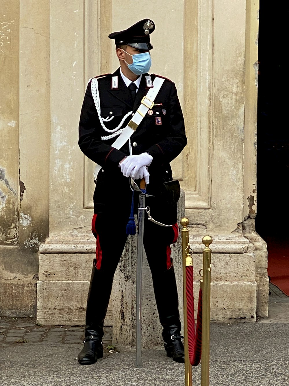 a person in a uniform with a mask and a pipe