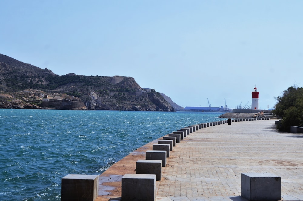 a dock leading to a lighthouse