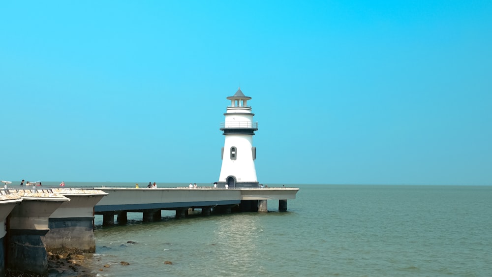 a white lighthouse on a pier