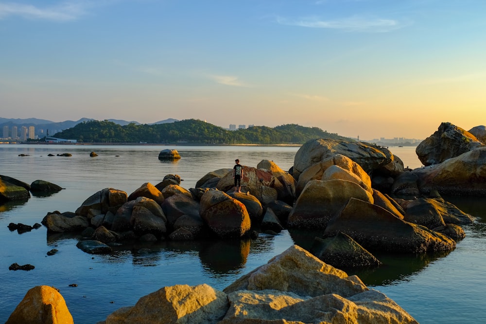 a person standing on a rock in the water