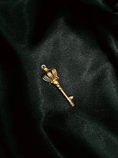 a gold key on a black surface