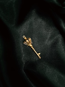 a gold key on a black surface