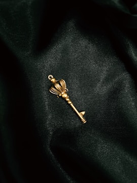 a gold key on a black surface