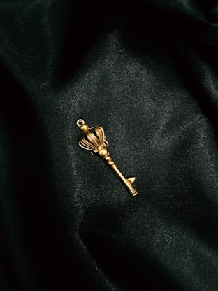 a gold key on a black surface