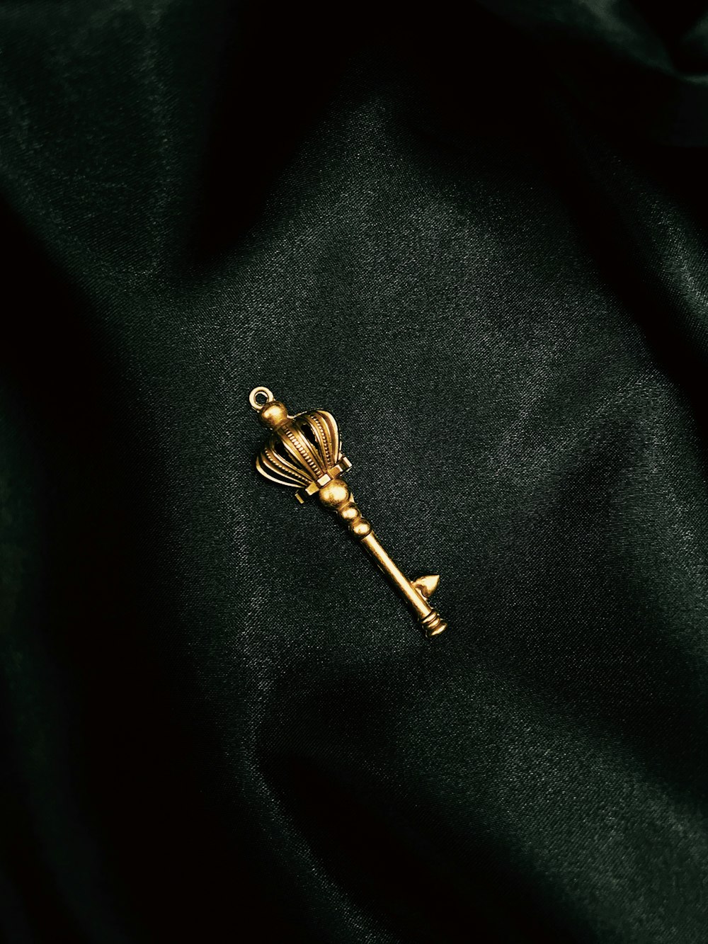 a gold key on a black surface