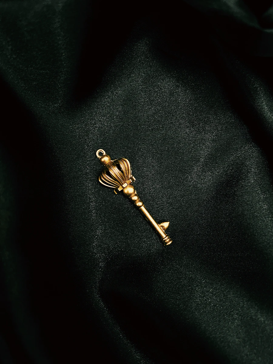A gold key on a black surface