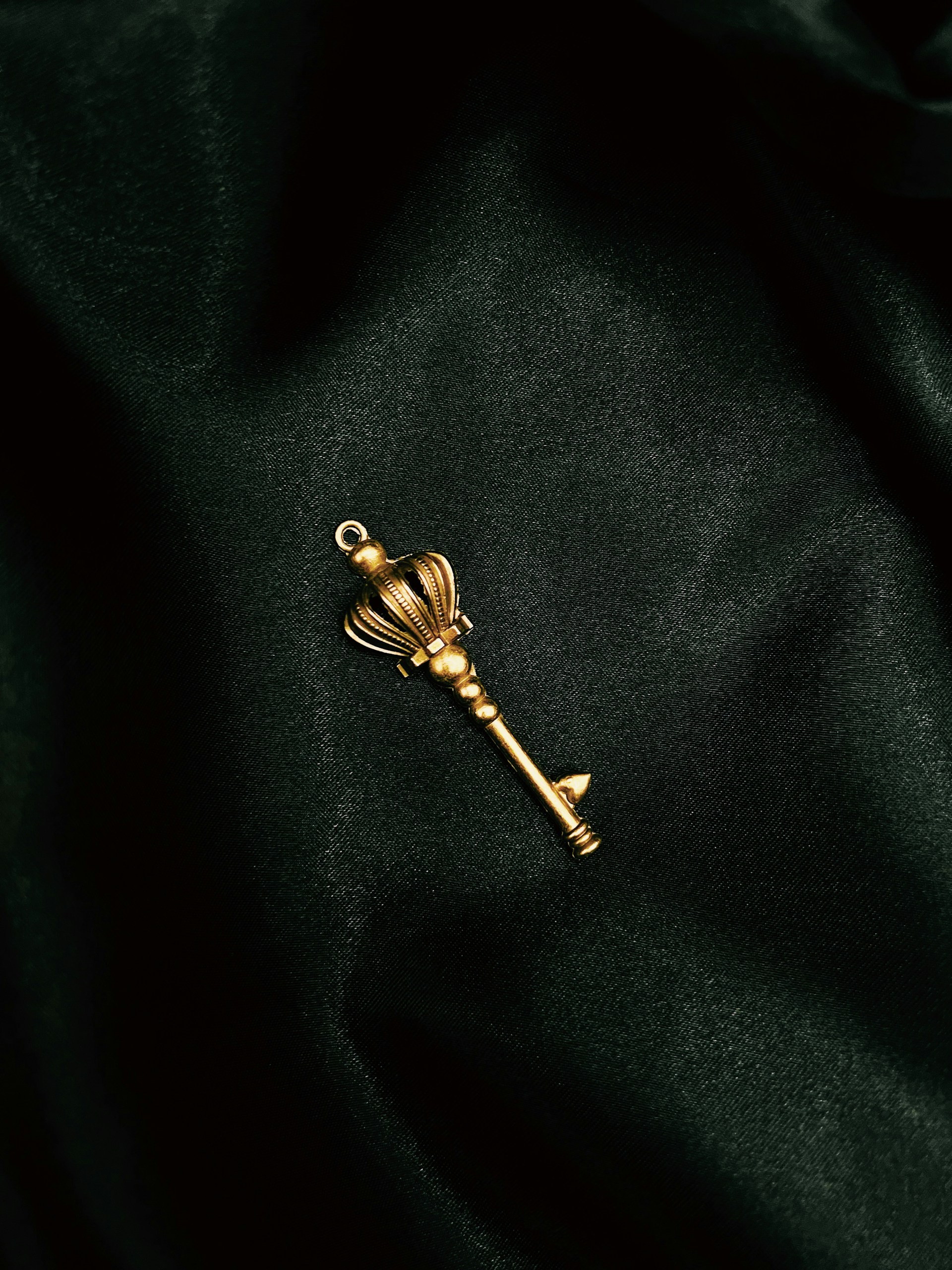 a gold key on a black surface