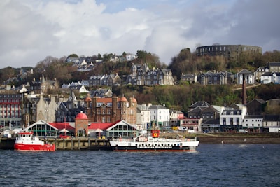 a boat in the water by a town