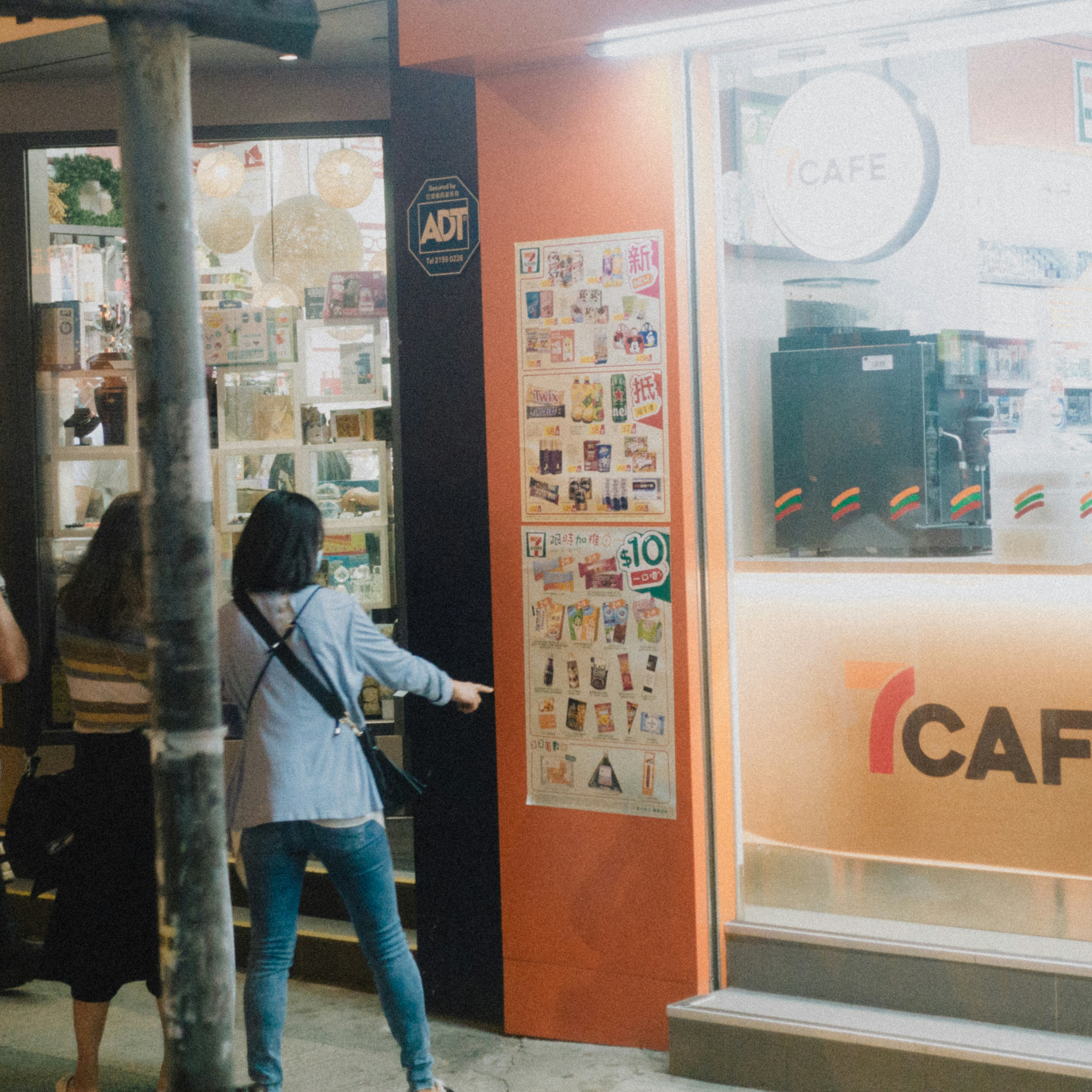 A person standing in front of a storefront photo – Free Hong kong Image ...