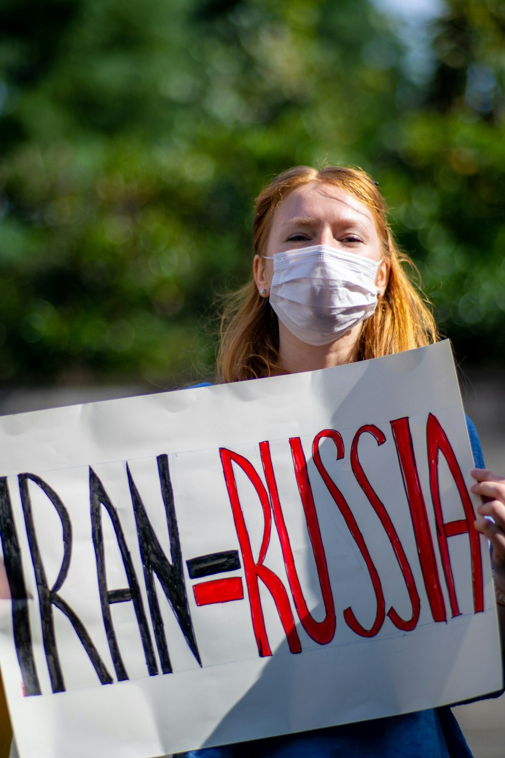 a woman holding a sign