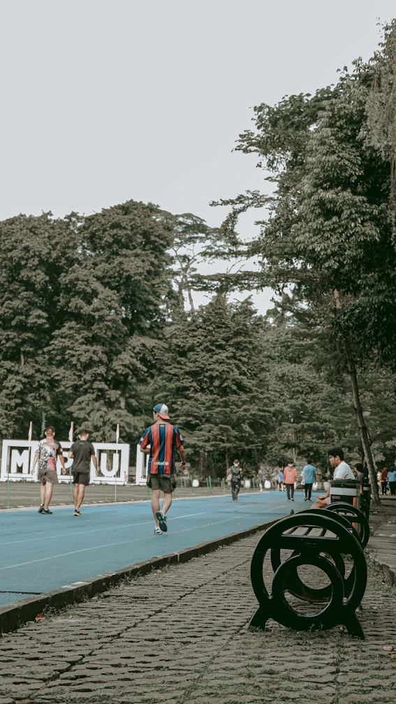 A vibrant outdoor scene showing athletes using eco-friendly sports gear surrounded by lush greenery.