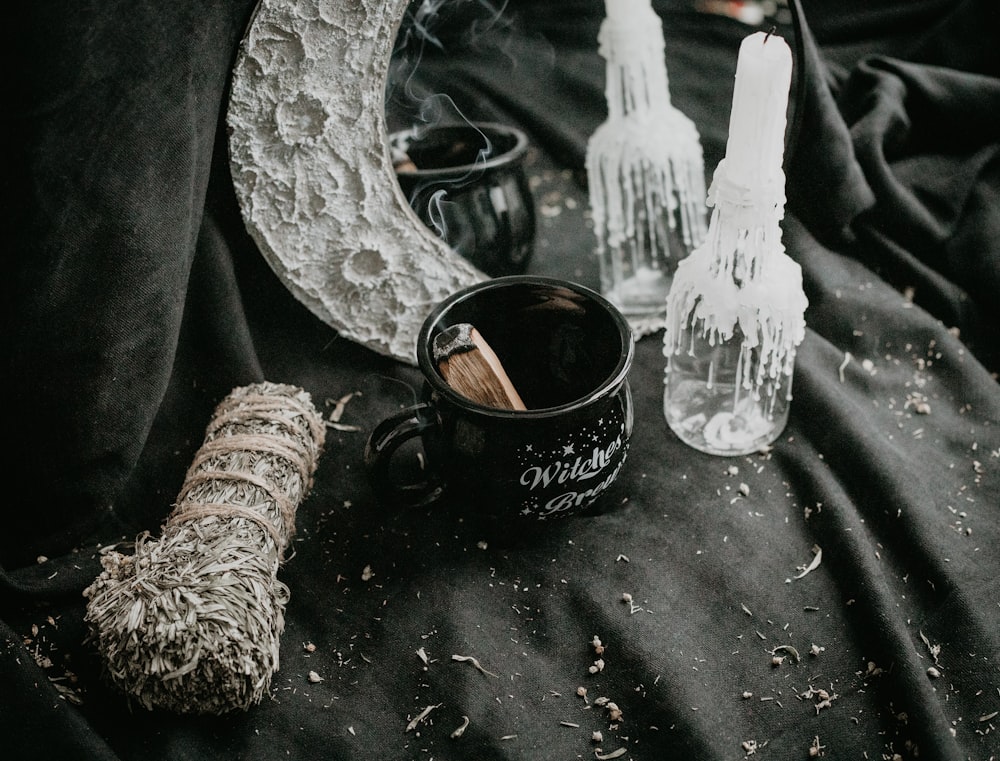 a cup and a pair of gloves on a table