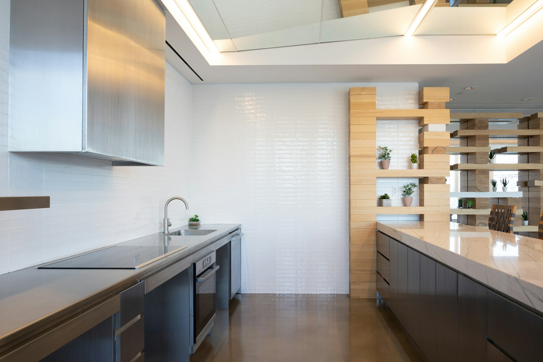 bright kitchen with stainless steel countertops