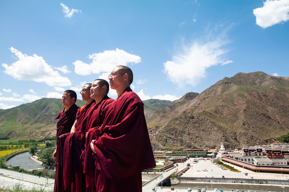 a group of people wearing red robes