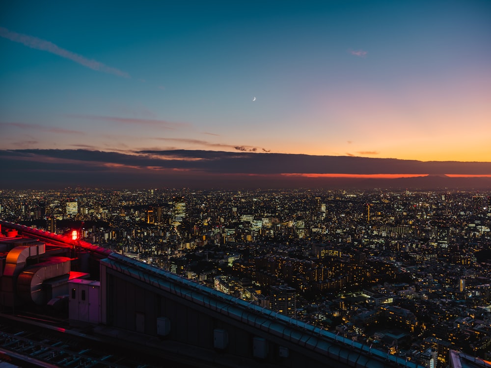 a city with a bridge and a sunset