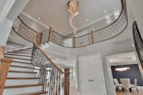 a staircase with a chandelier