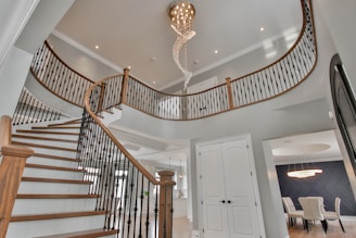 a staircase with a chandelier