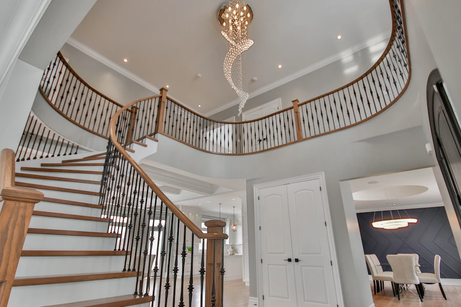 Sculptural stair beneath a chandelier