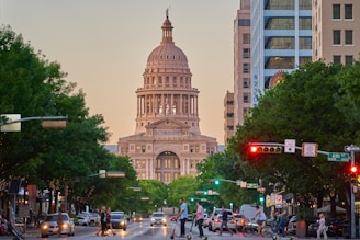 a large building towers over Texas State Capitol
