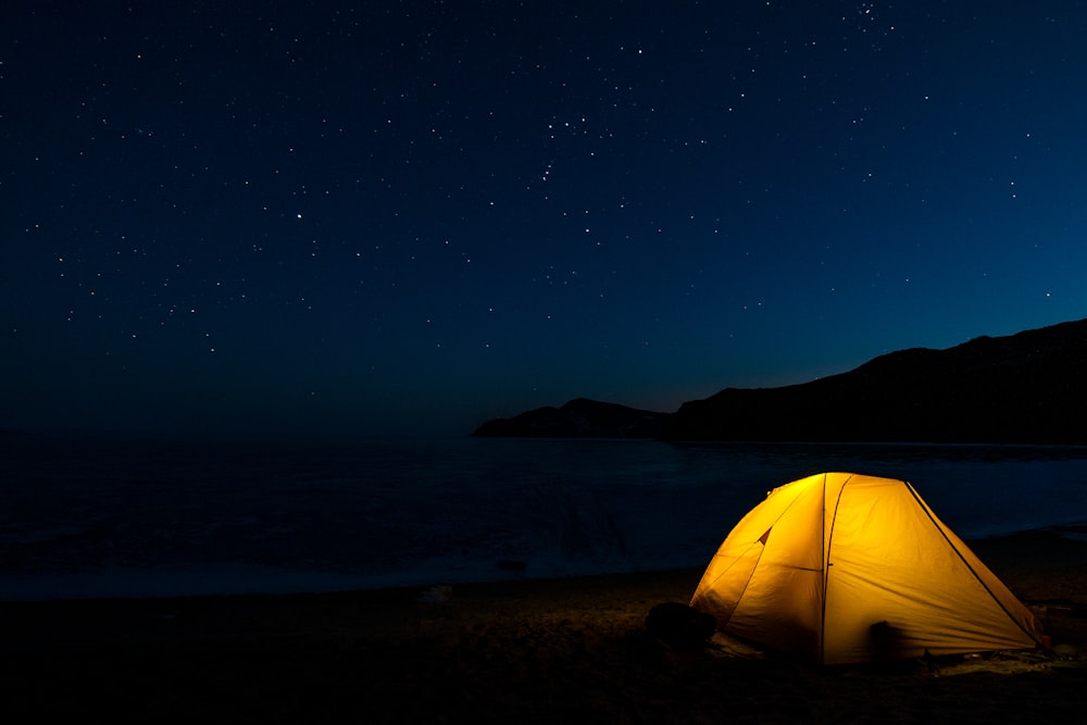 a tent on a beach at night