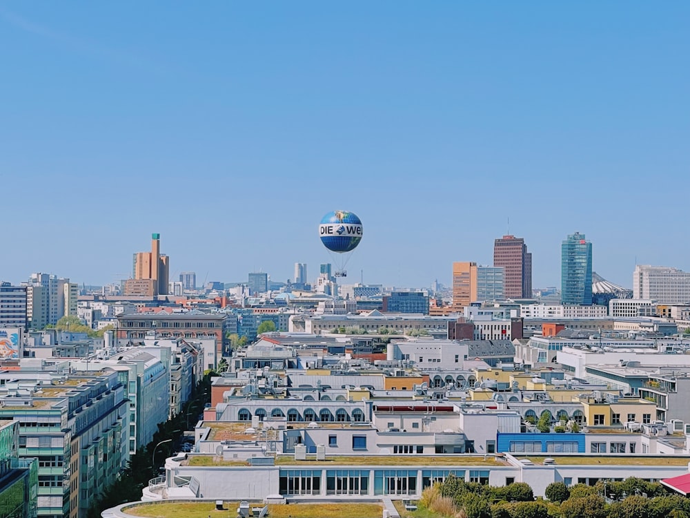 a hot air balloon flying over a city